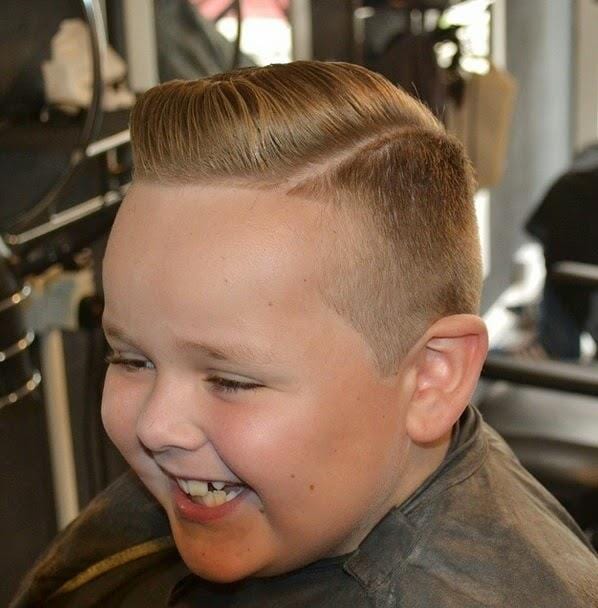 Young Boy Smiling At Barber's — Haircuts Services in Wilsonton, Qld