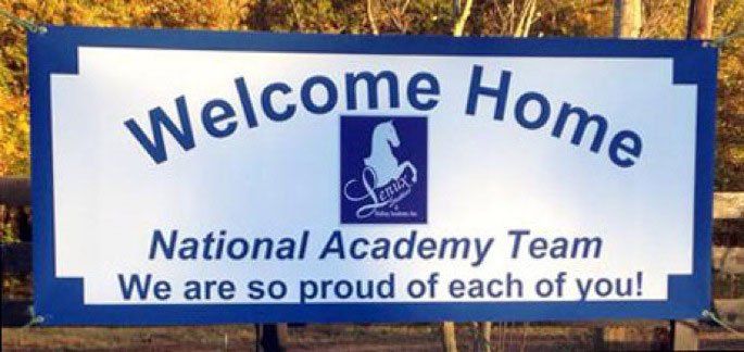 photo of sign welcoming home Lenux Stables National Academy Team