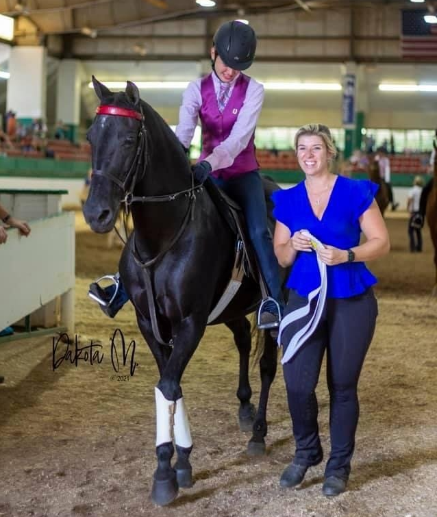 photo of Lenux Stables academy rider on horse, with instructor after leaving ring in horse show competition