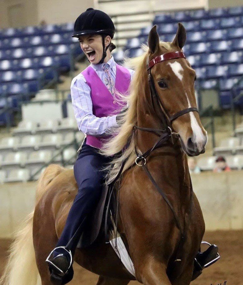 photo of smiling girl at horse show on American Saddlebred horse named 