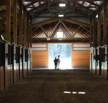 photo of trainer leaving Lenux Stables barn with horse