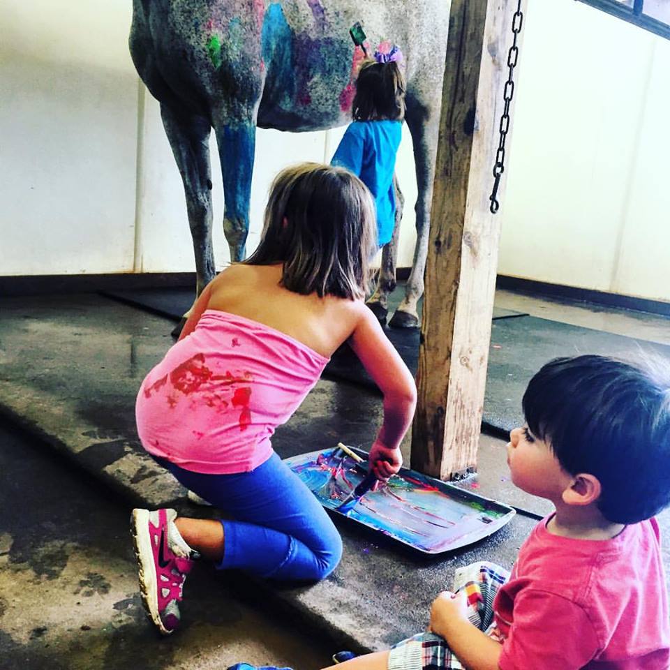 photo of kids painting a horse during a Lenux riding camp
