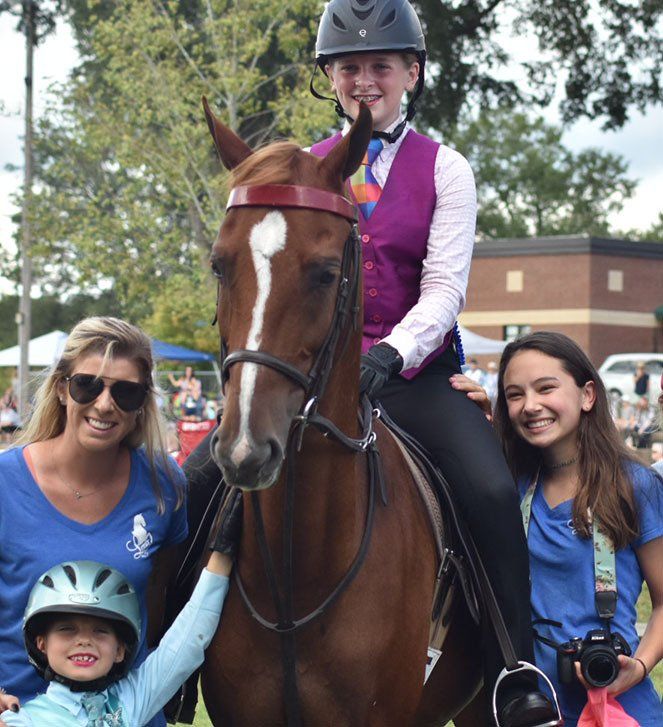 photo of young rider, two other girls and instructor with American Saddlebred horse named 