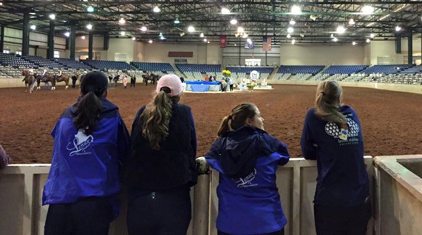 photo of Lenux Stables instructors awaiting announcement of ribbon winners at horse show competition