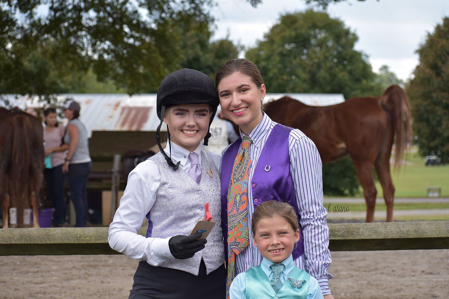 photo of three smiling Lenux academy riders at horse show