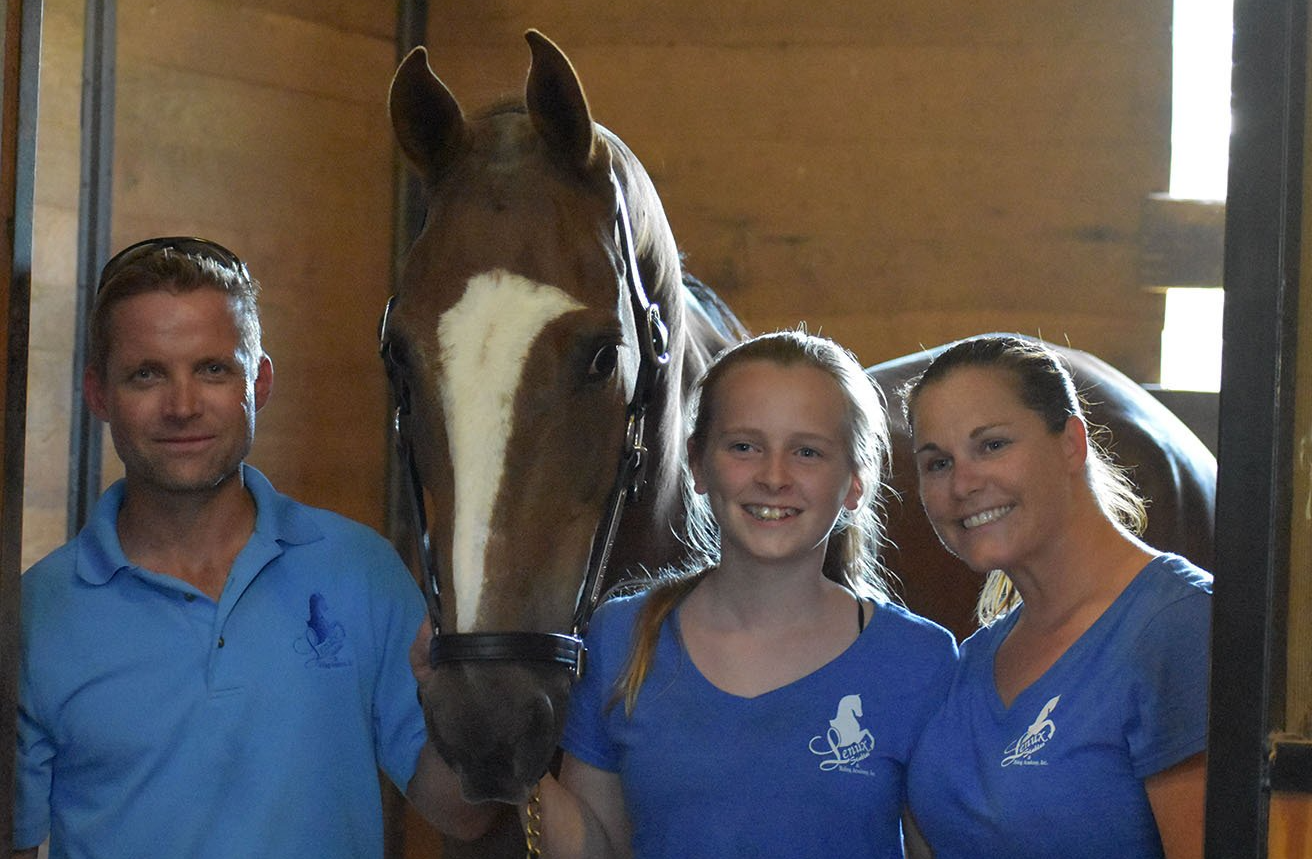 photo of Lenux Stables owners Quintus and Brooke VanderSpuy and rider Emma Wittgraefe in stall with American Saddlebred horse