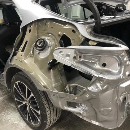 The rear end of a car is being dismantled.