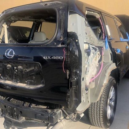 A black lexus gx460 is being dismantled.