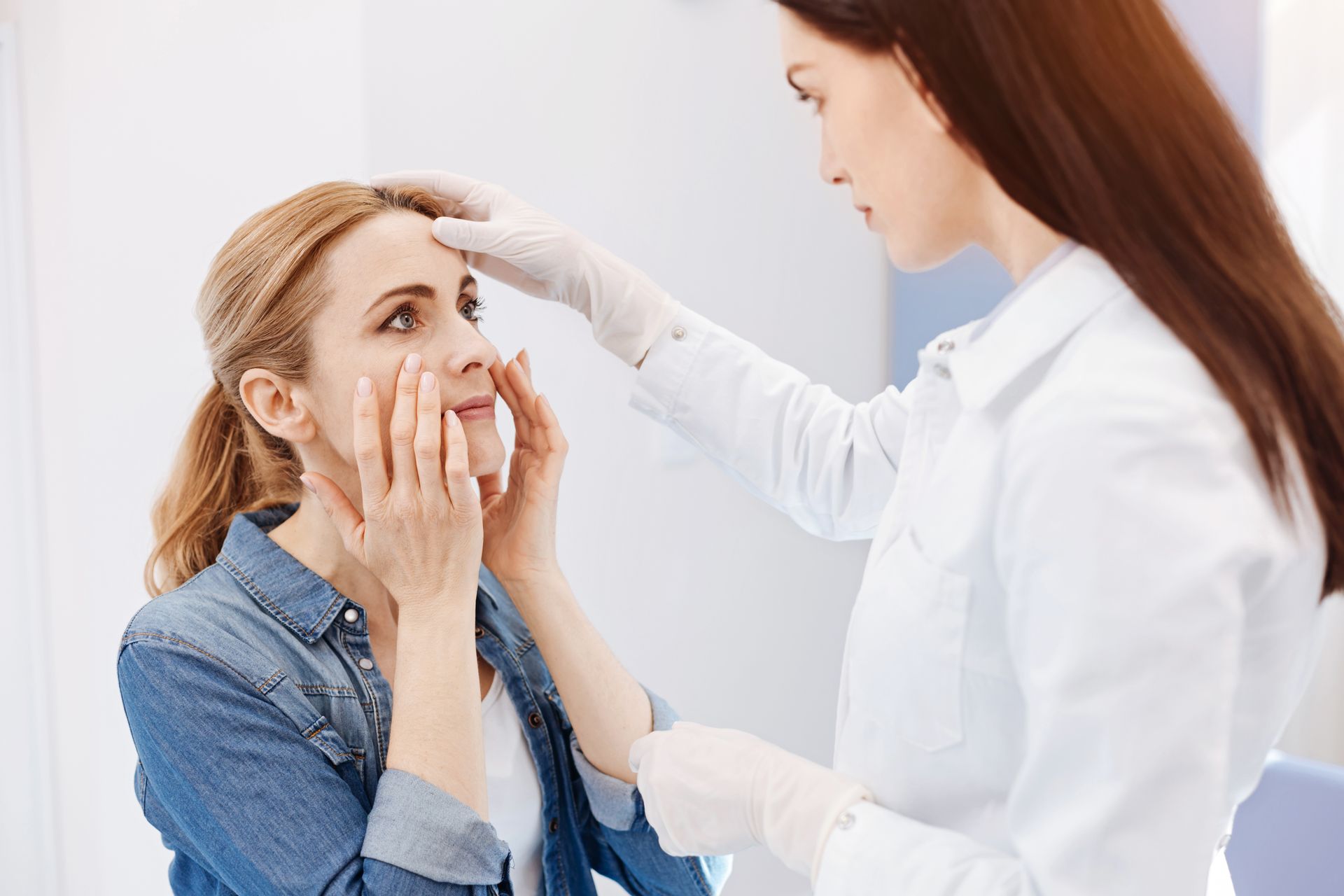 A woman is getting her eyes examined by a doctor.