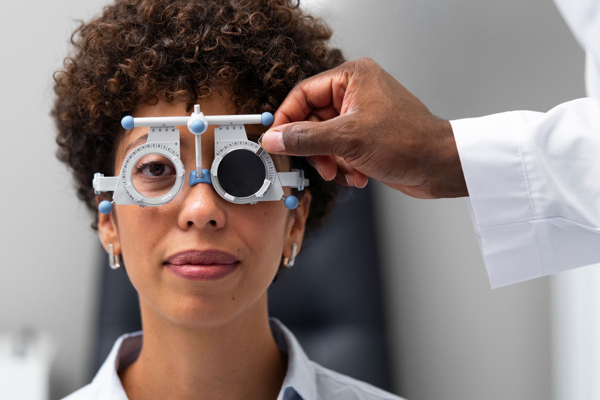 A woman is getting her eyes checked by an ophthalmologist.