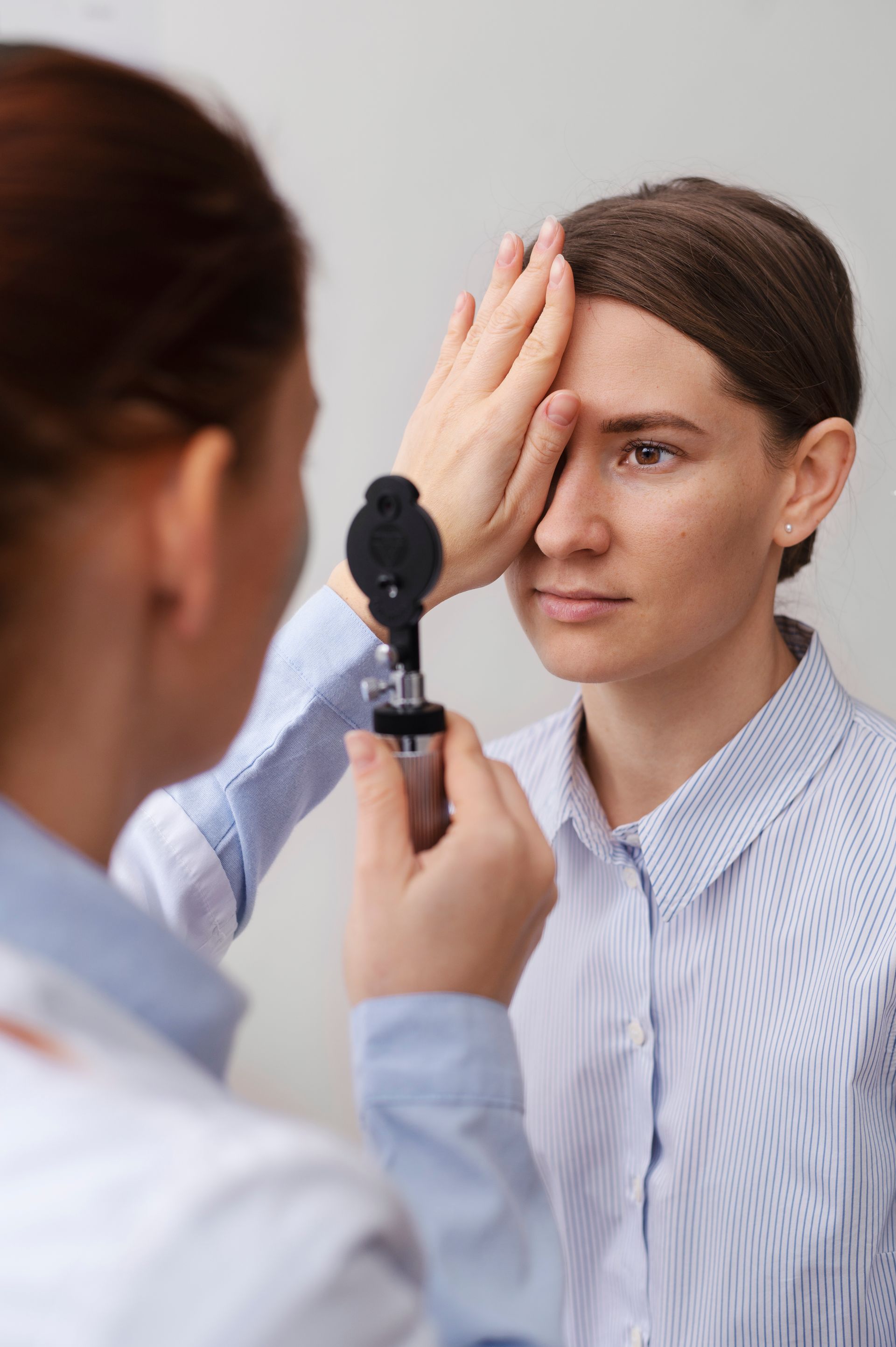 A woman is getting her eyes examined by an ophthalmologist.