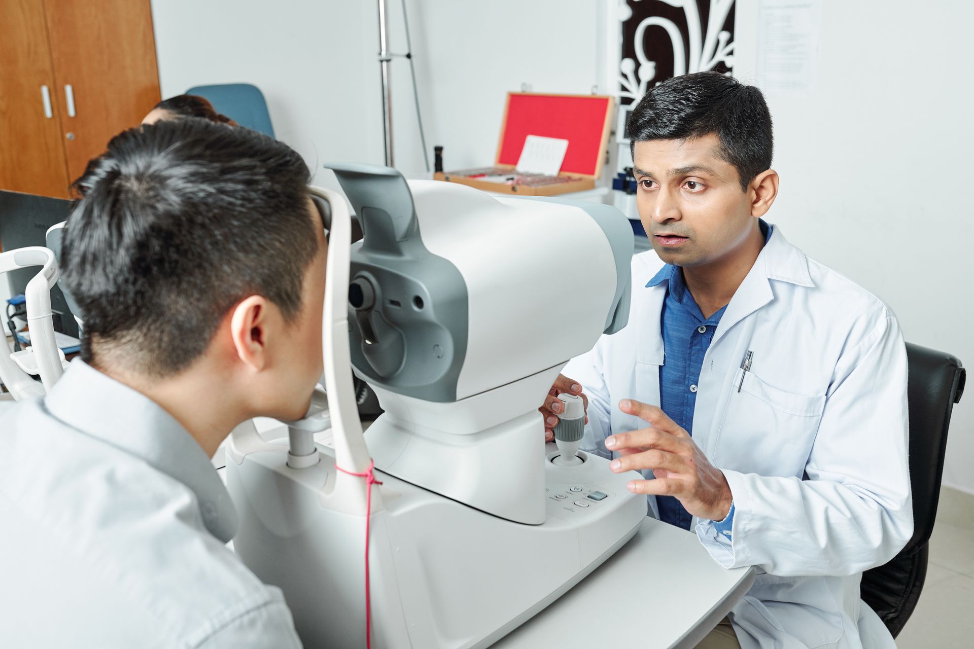 A man is getting his eyes examined by an ophthalmologist.