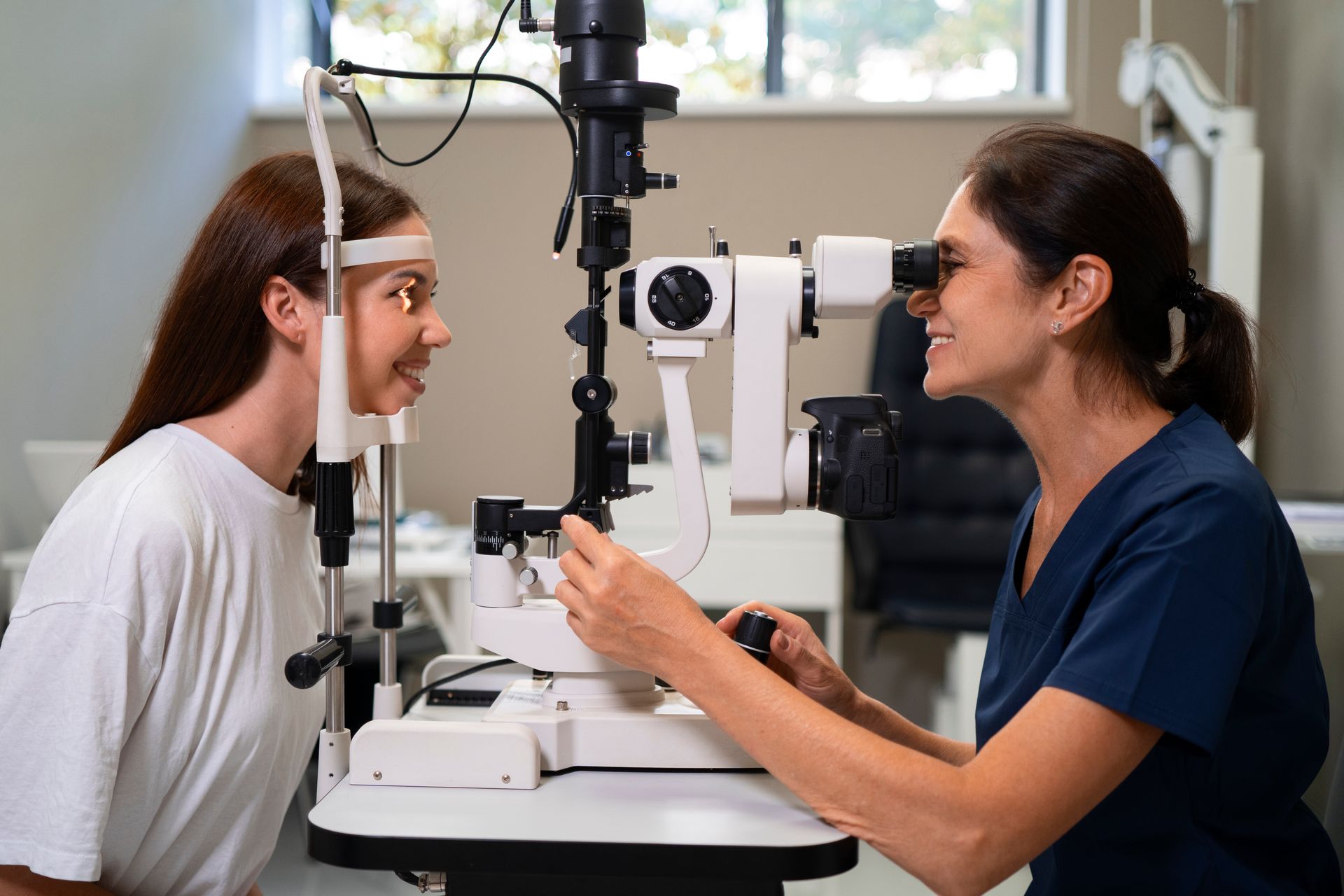 A woman is getting her eyes examined by an ophthalmologist.