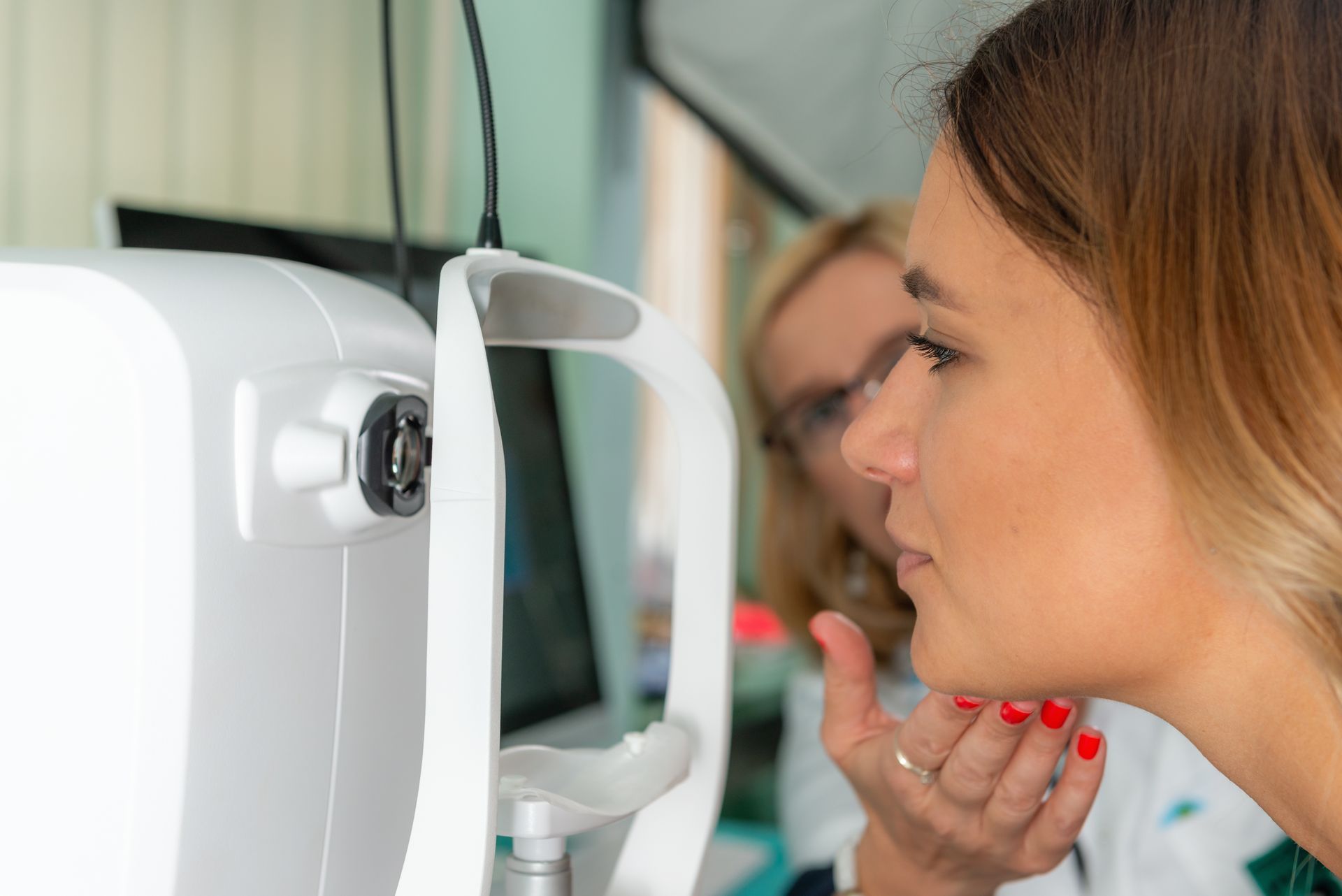 A woman is getting her eyes checked by an ophthalmologist.