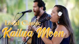 Two musicians singing, ukulele in hand.  Text reads “Kailua Moon, Local Classic”. Blue and gold tones.
