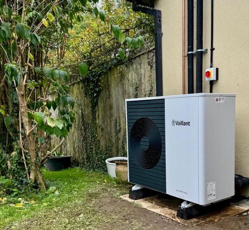 New Vaillant heat pump installation Exeter against a red brick wall.