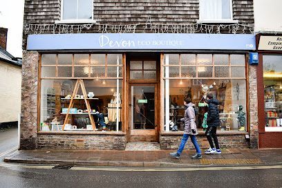 The front of an eco store with people walking past and looking inside.
