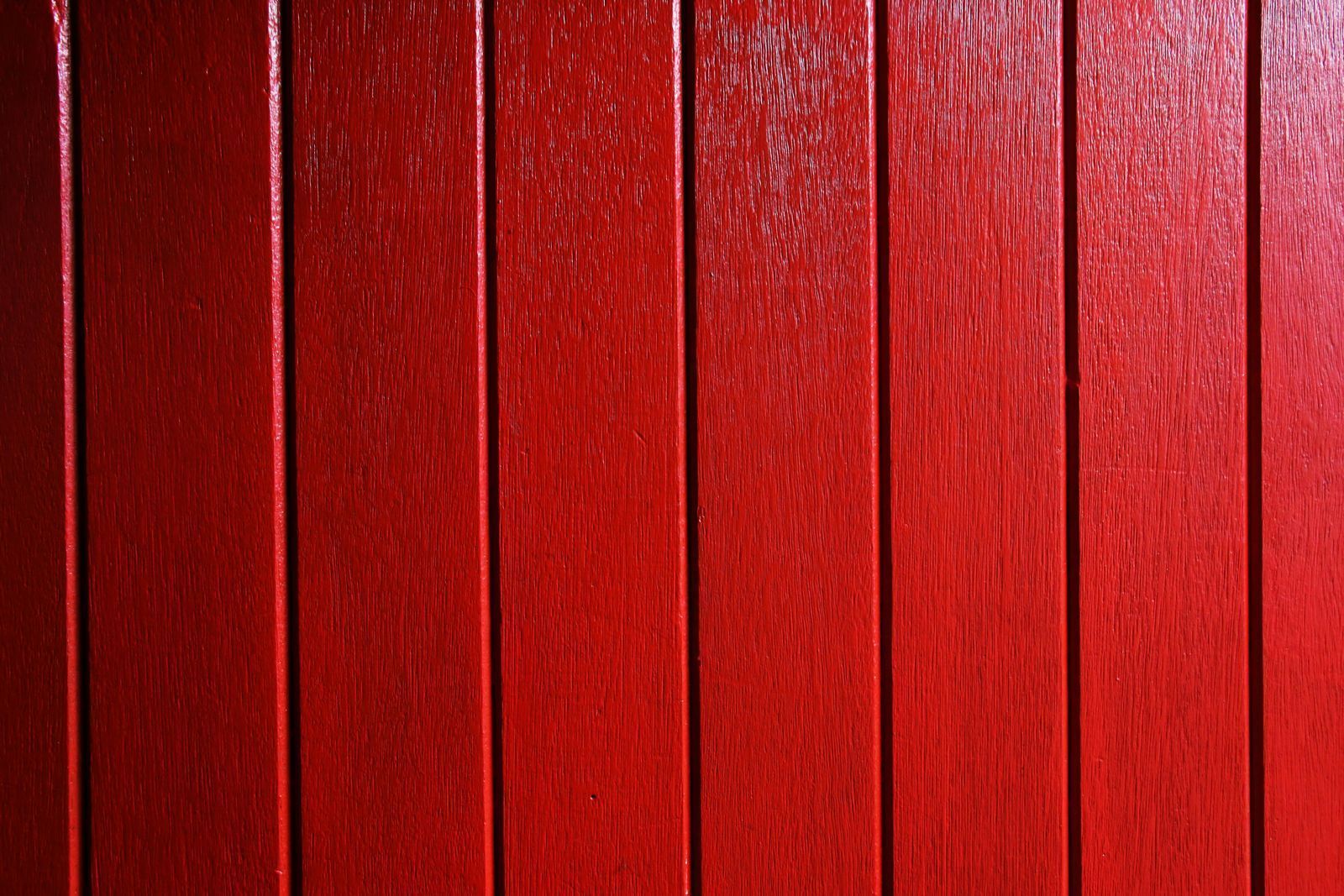 Red painted vertical wooden planks.