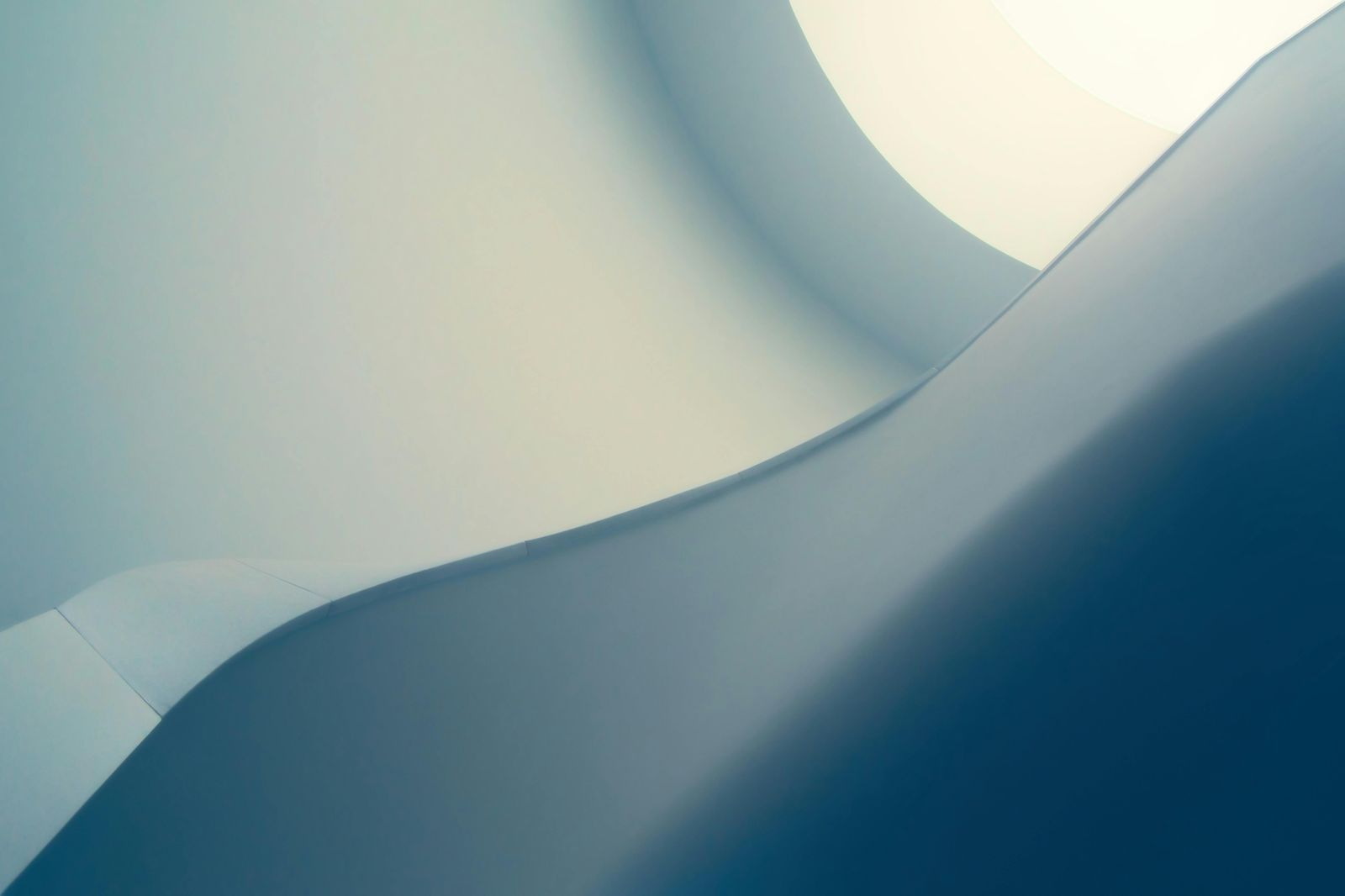 A close up of a blue and white curve on a white background.