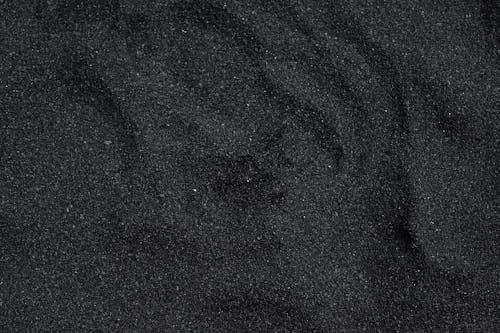 A close up of a pile of black sand.