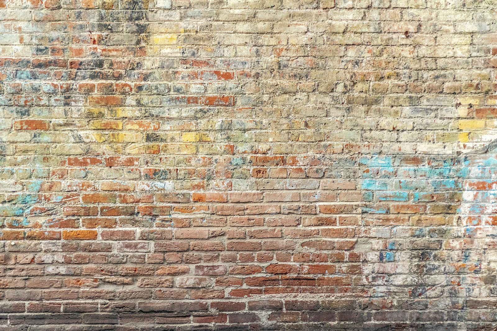 A close up of a brick wall with graffiti on it.