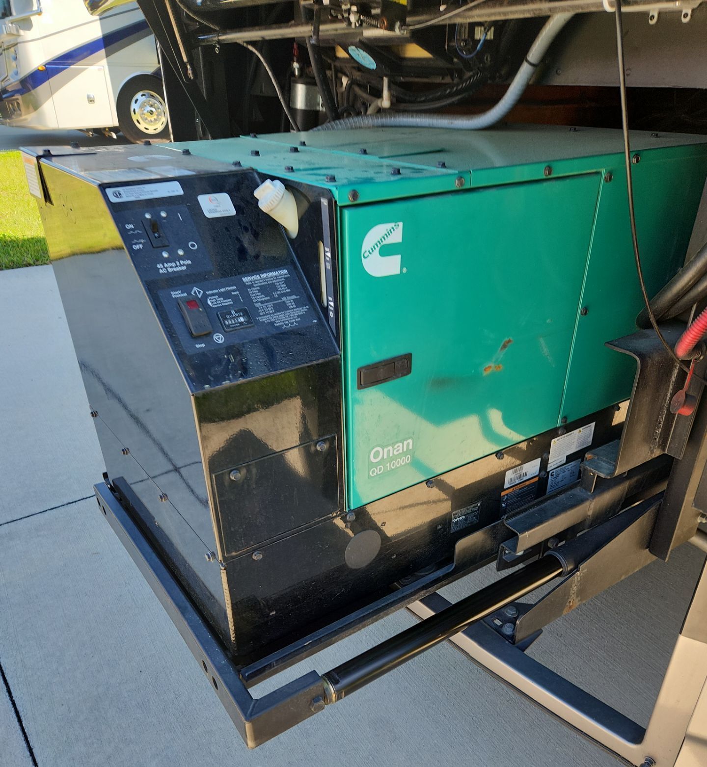A man is cleaning the roof of a van with a sponge.