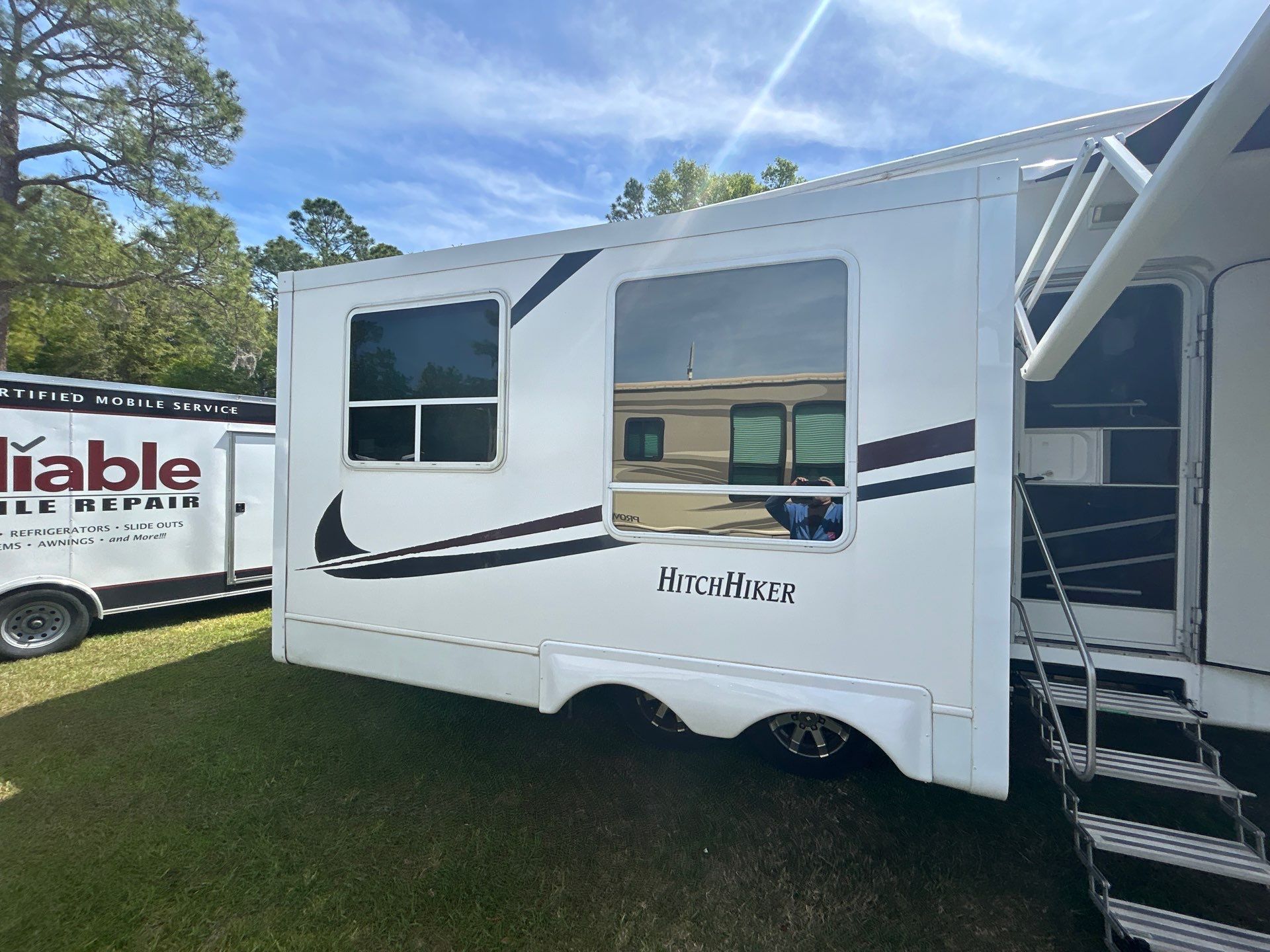 A man is working on a truck engine in a garage.