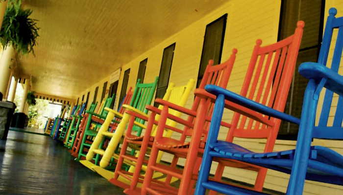 Blue house with white trim, attached garage, and front porch.