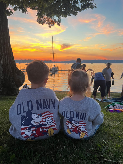Bedroom with a bed, dresser, mirror, and window, blue walls, and neutral carpet.