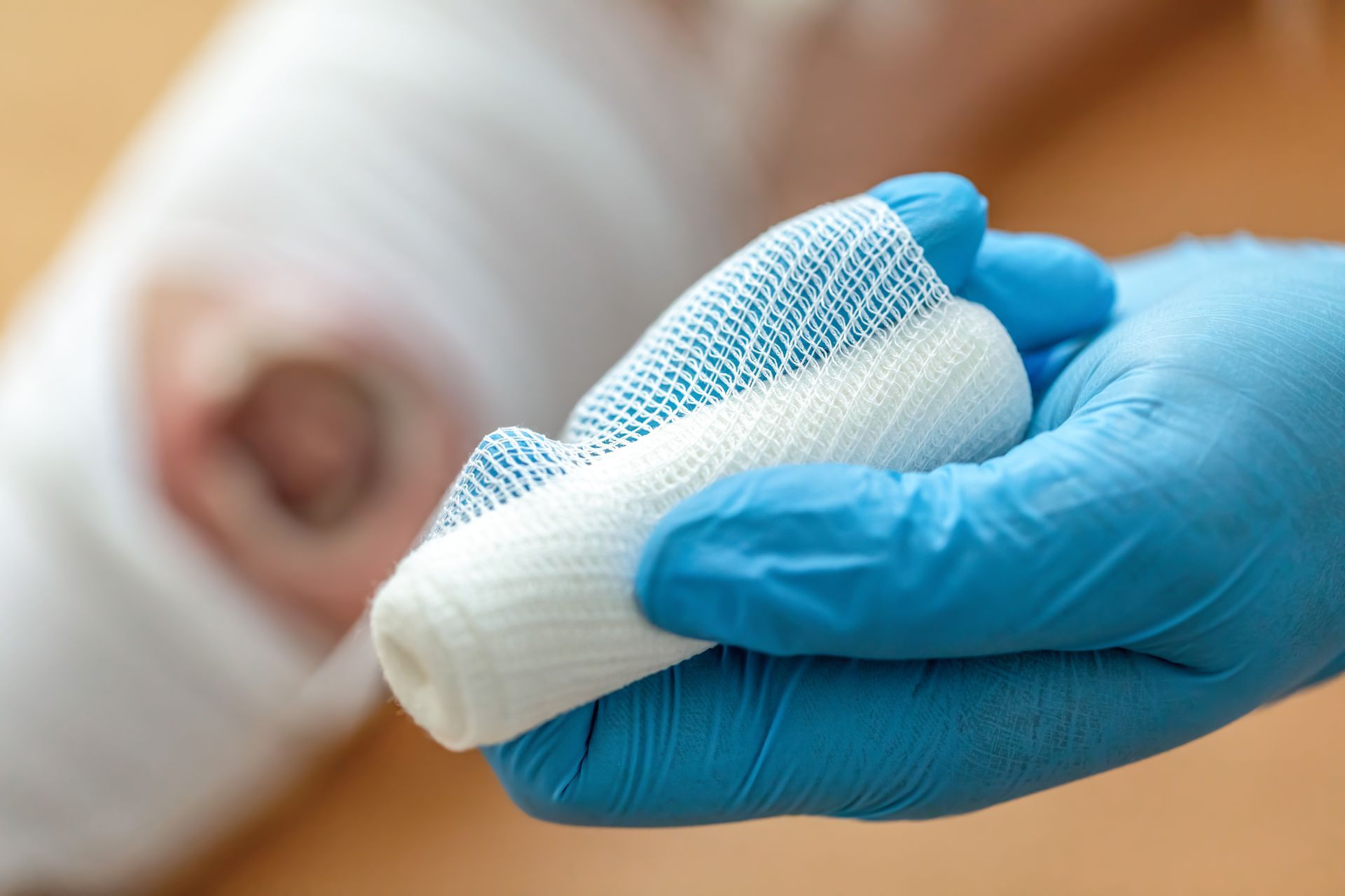 A woman is smiling and touching her face with her hands.