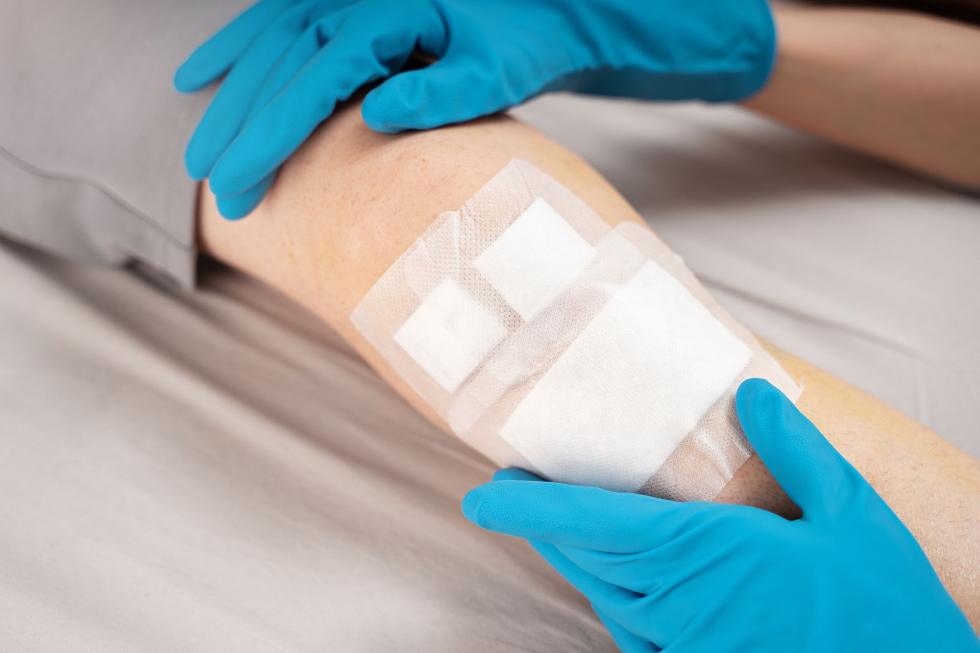 A man with a beard is standing in front of a building with his arms crossed.