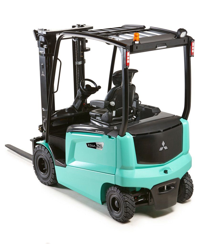 A green forklift is sitting on a white surface.