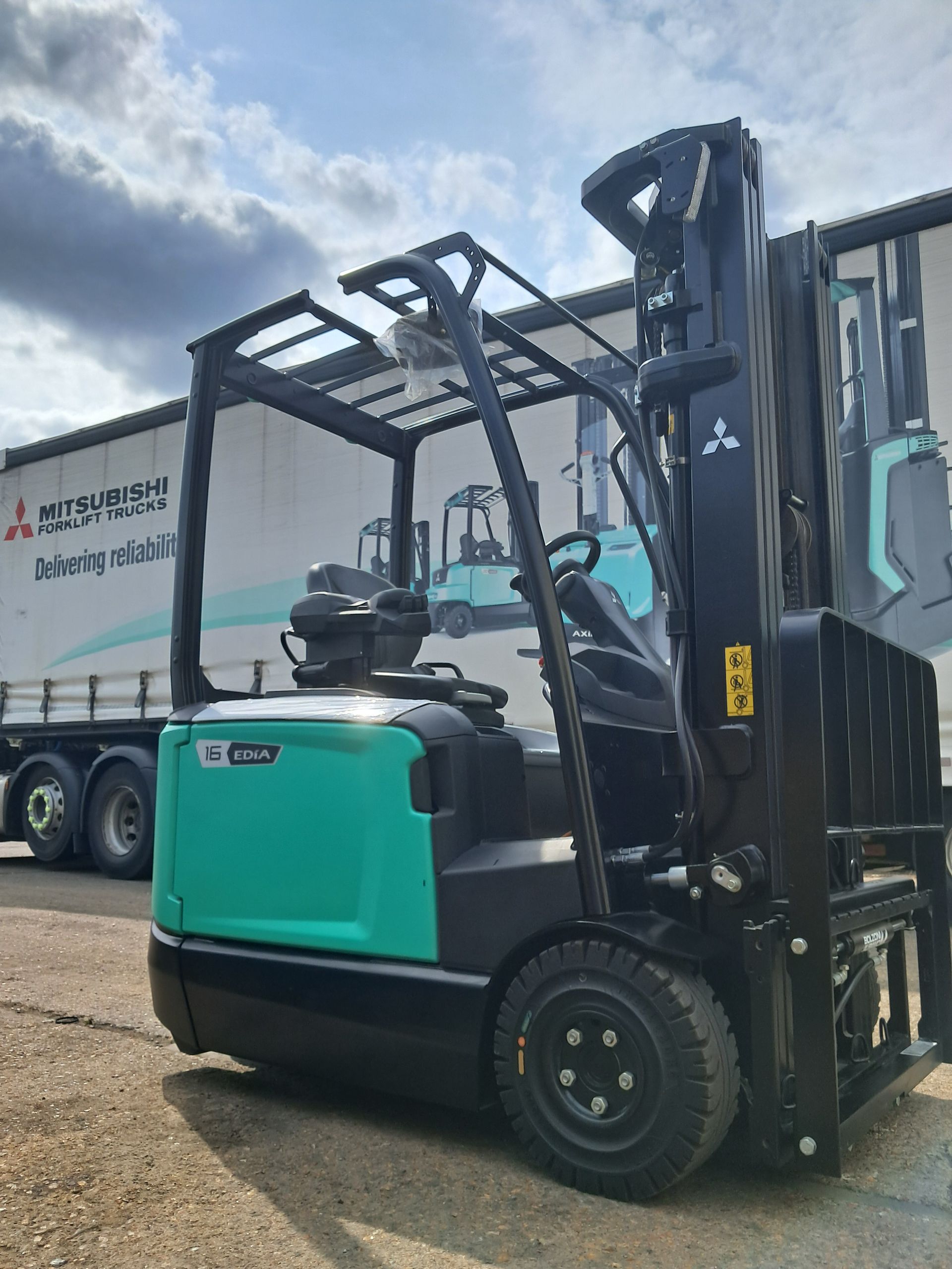 A green and black forklift on a white background.