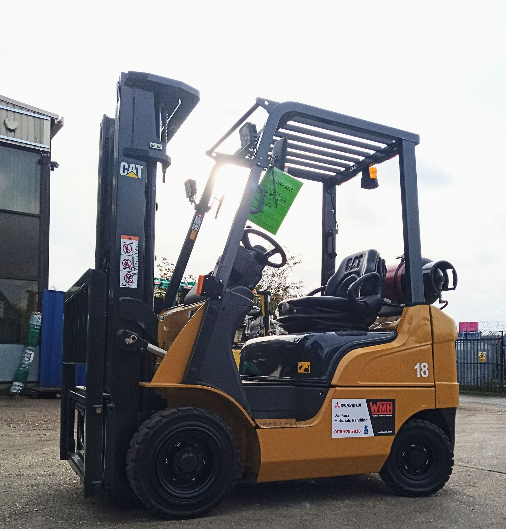 A cat forklift is parked in a parking lot