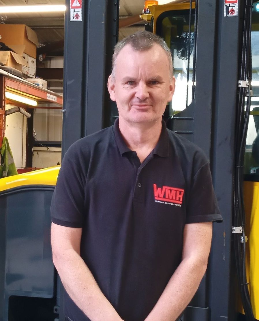 A man wearing a black shirt with the word wmb on it