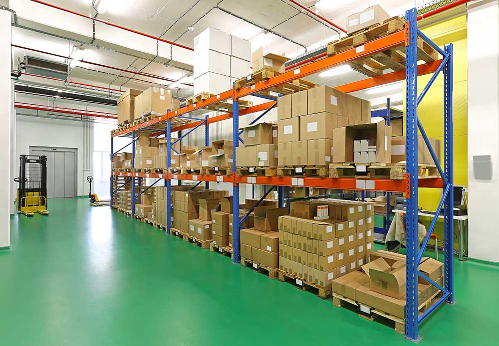 A large warehouse filled with lots of boxes and pallets.