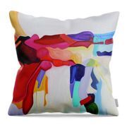 A pillow with a colorful painting on it on a white background.