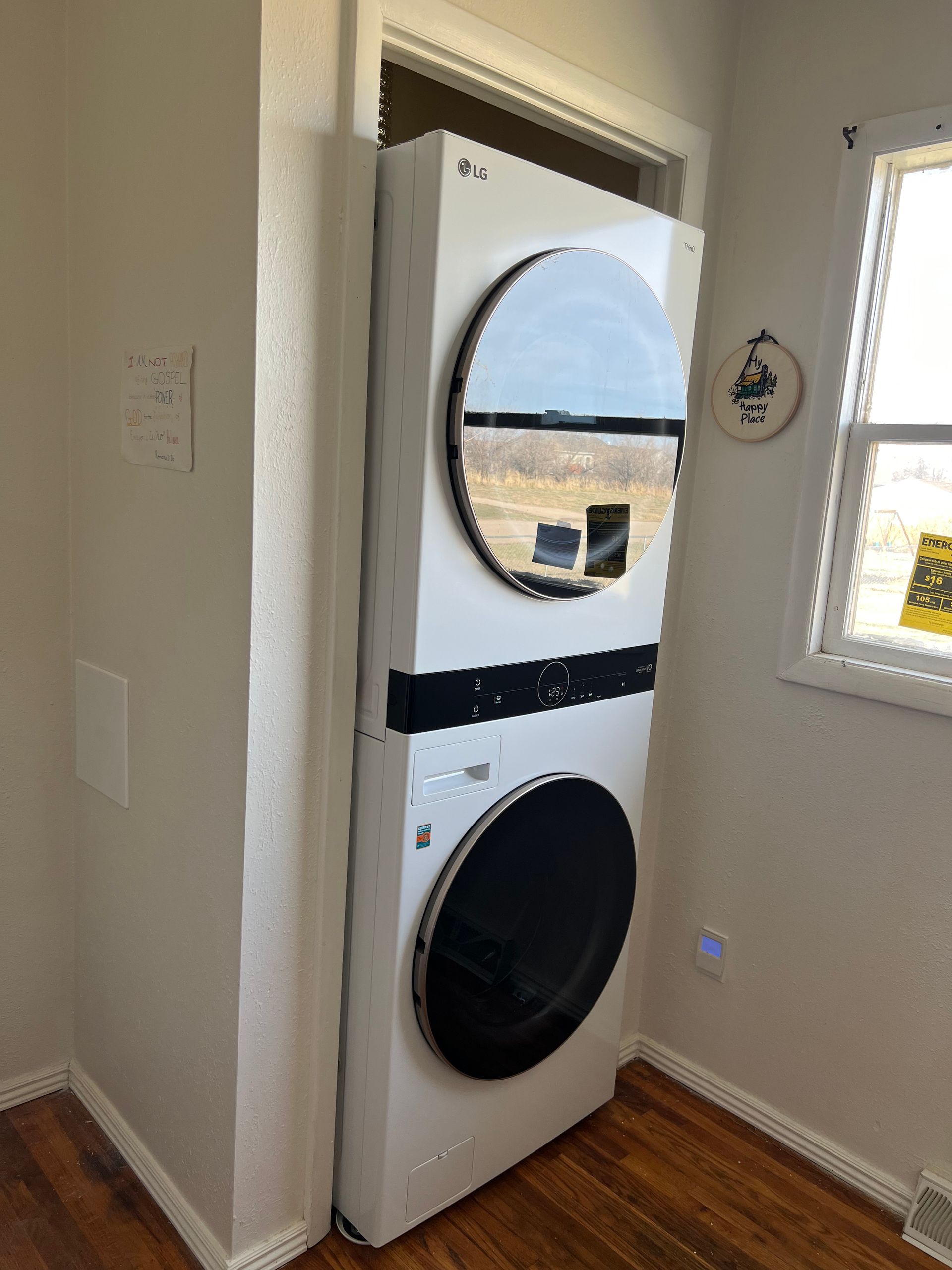 A washer and dryer are stacked on top of each other in a laundry room.