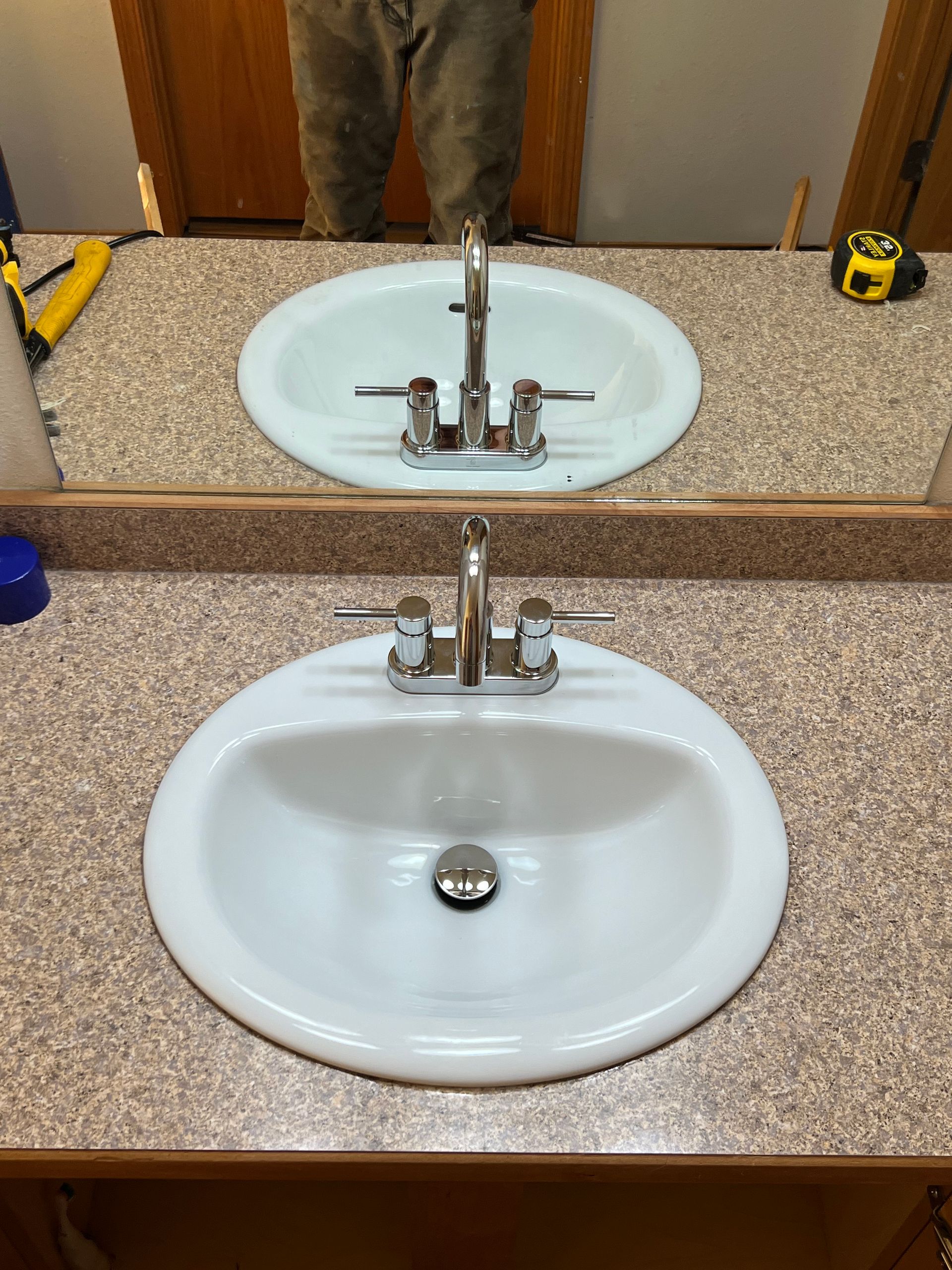 A bathroom sink with two sinks and a mirror.
