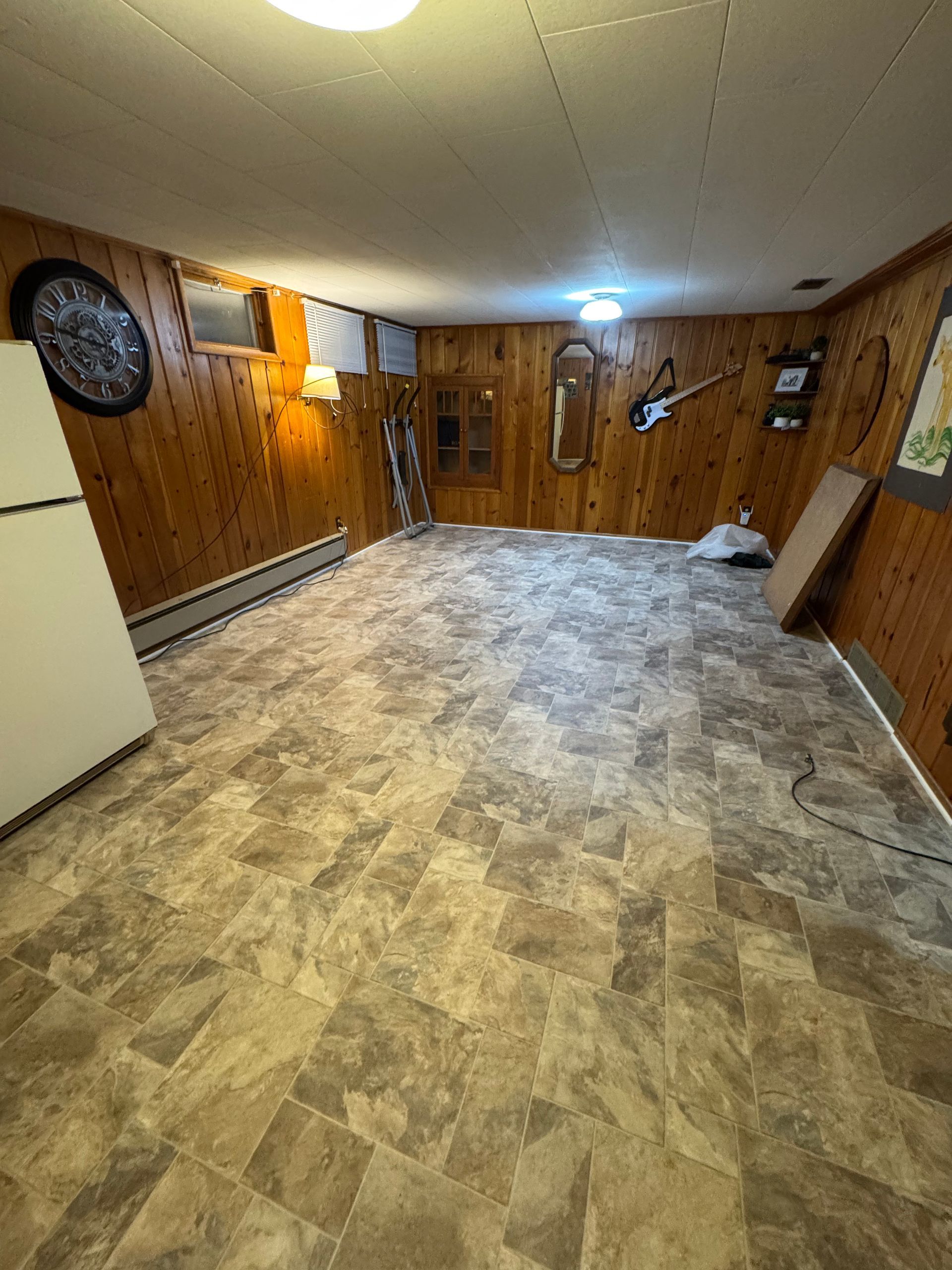 There is a refrigerator in the corner of the room.