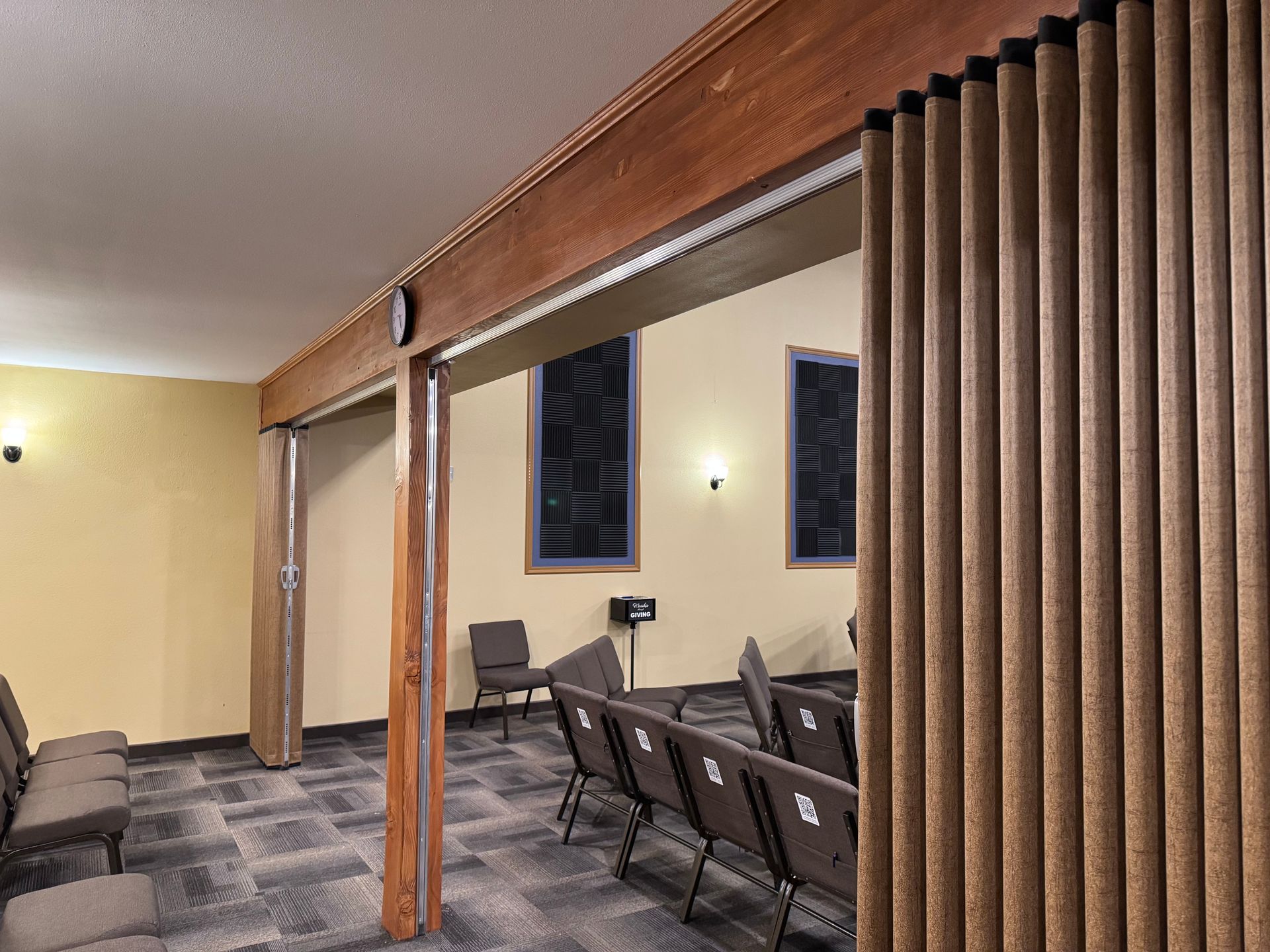 A waiting room with folding curtains and chairs