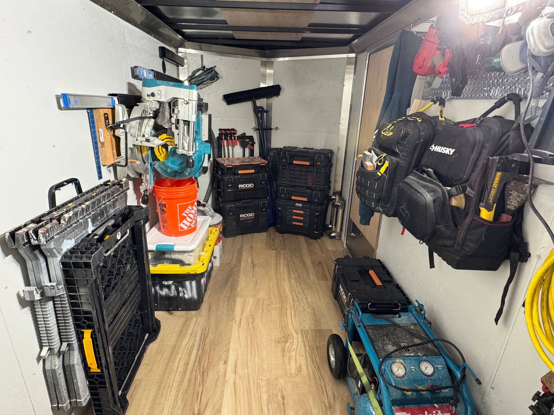 The inside of a trailer filled with tools and a generator.