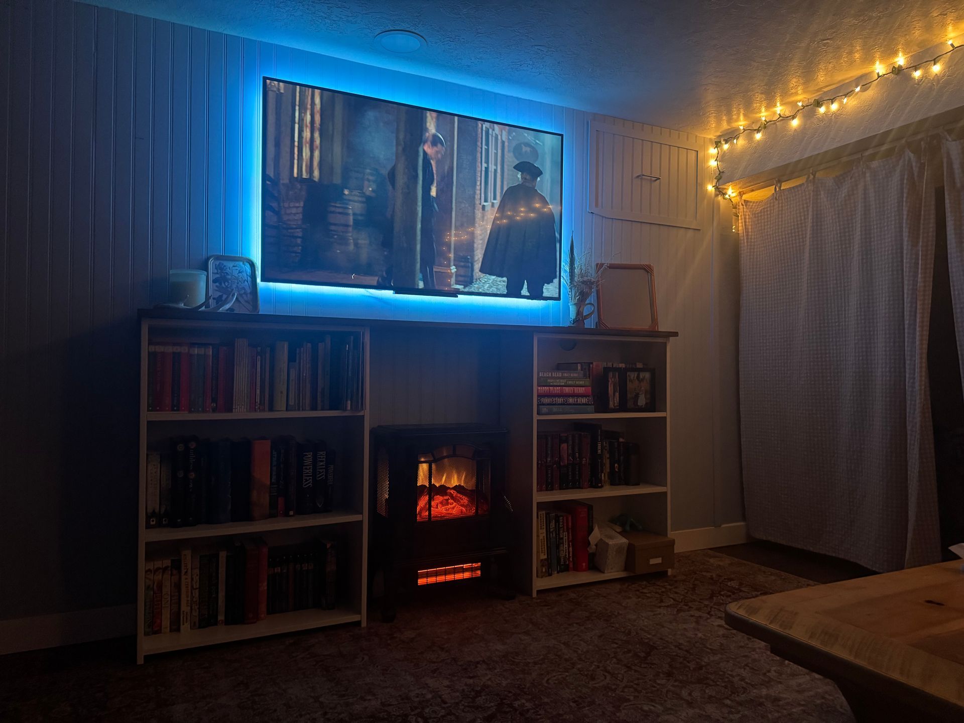 A living room with a fireplace and a flat screen tv.
