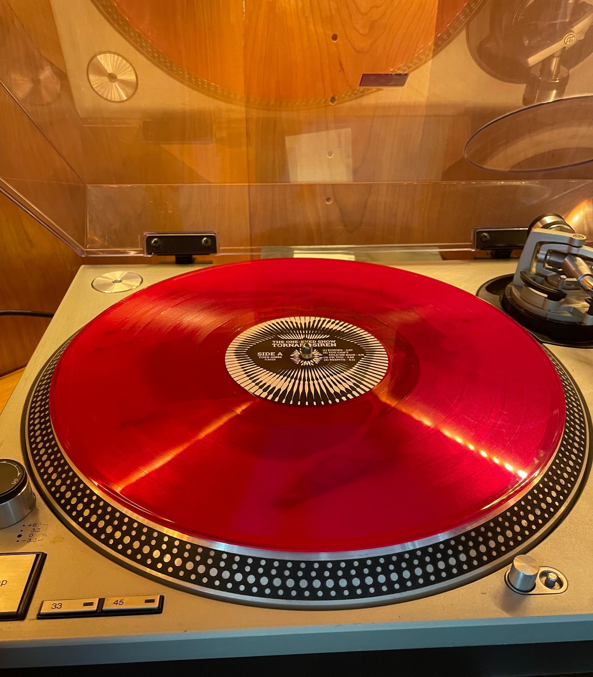 a record player with a red record on it. the record is 