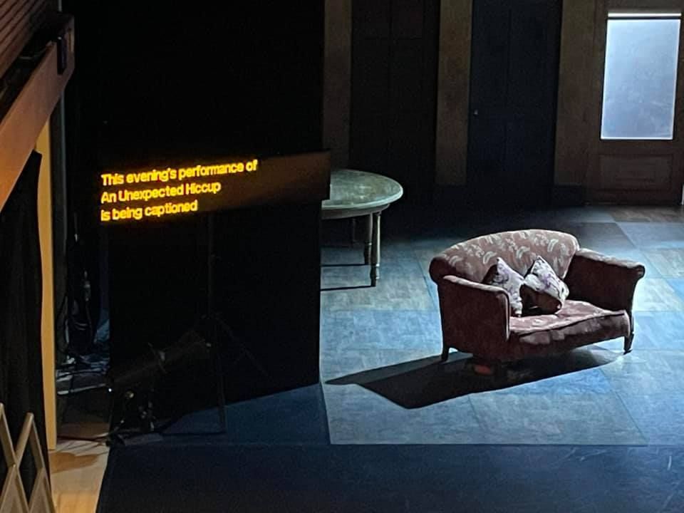 Hanging caption unit at theatre displaying text.