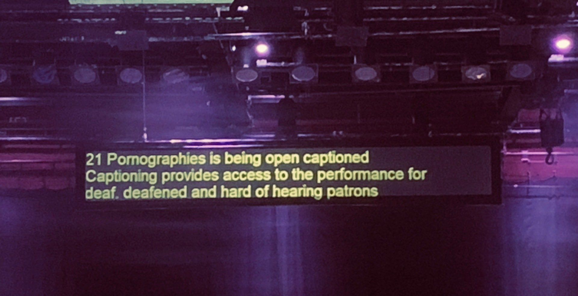 Hanging caption unit at theatre displaying text.