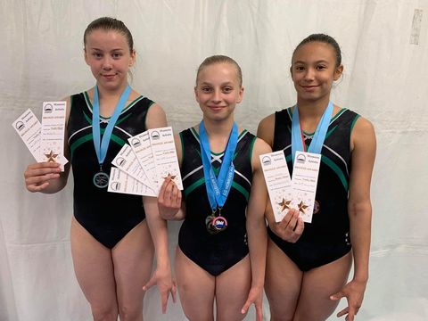 Gymnasts with medals smiling after their competition
