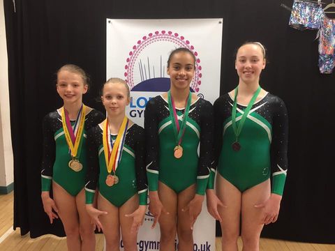 Level 3 gymnasts with medals after competing at the Summer Levels Championships