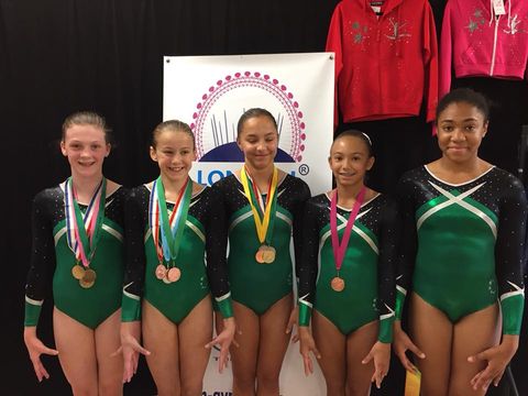 Level 4 gymnasts with medals after the competition