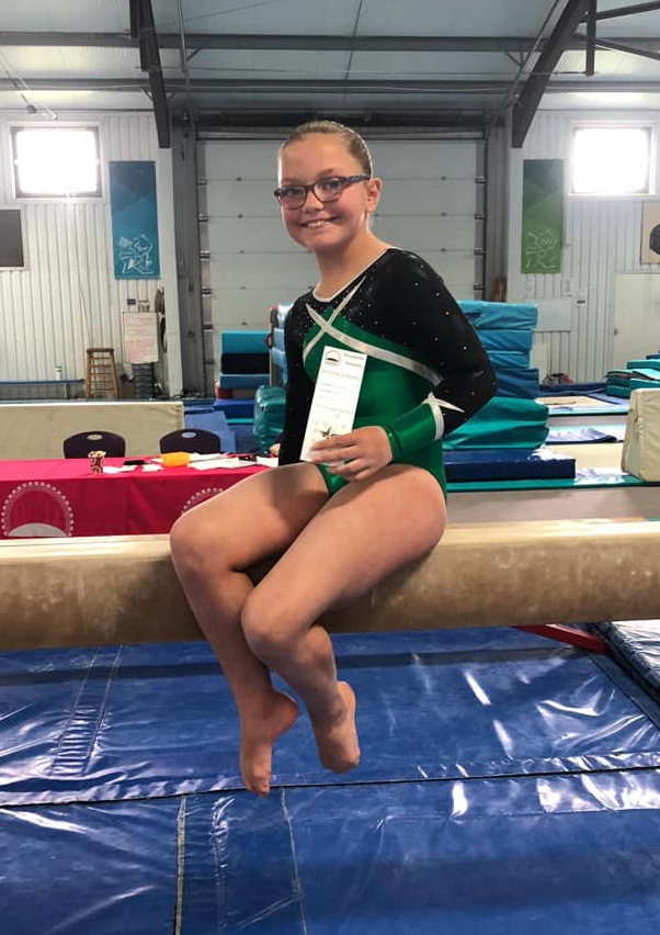 Gymnast sat on the beam after a competition